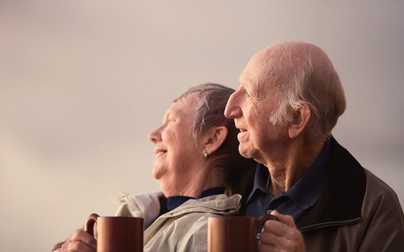 Happy elderly couple drinking tea together