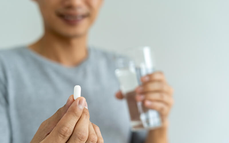 Blurred photo of individual taking Topiramate medication