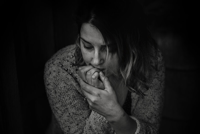 Black and white photo of a woman struggling with anxiety