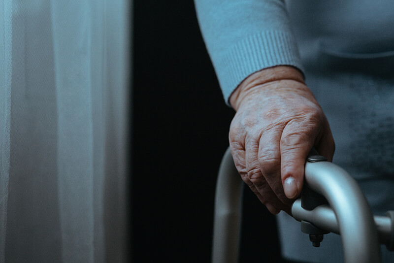 Close up of elderly woman’s hands on a walker